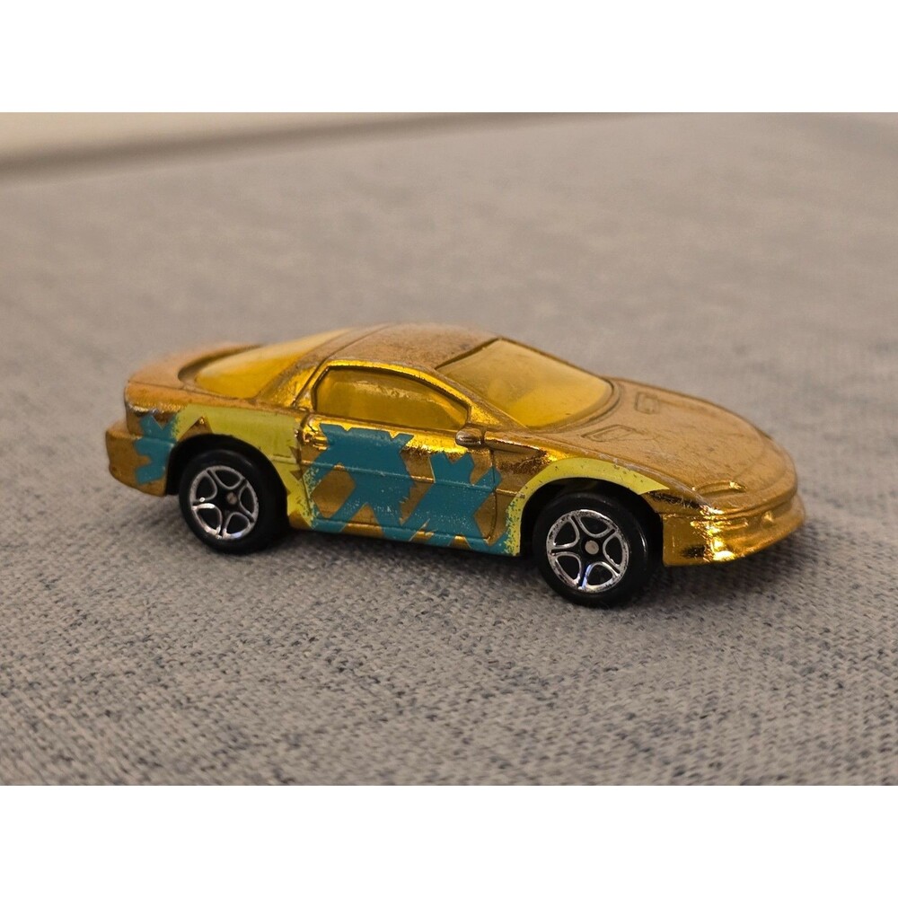 1993 MATCHBOX CAMARO Z-28 GOLD METALLIC- 1:63 - DIECAST CAR W/ BLUE & YELLOW